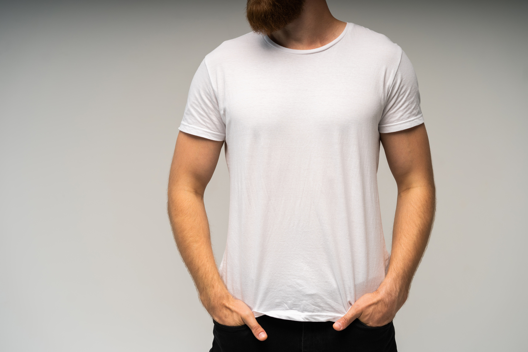 Young Man Wearing Blank White T-Shirt Isolated on White Background. Copy Space. Place for Advertisement. Front View.